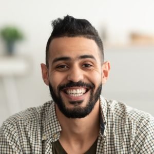 Portrait Of Handsome Young Arab Man Smiling And Looking At Camera Sitting On Sofa At Home E1687402178567 300x300 - GS Machine Automation